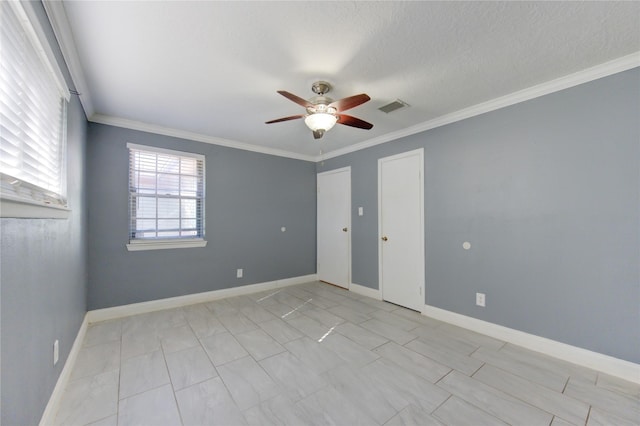 spare room featuring ceiling fan, ornamental molding, and a textured ceiling