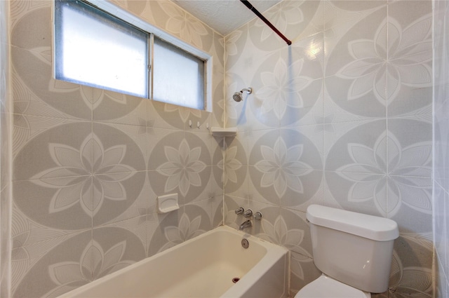 bathroom featuring tiled shower / bath combo and toilet