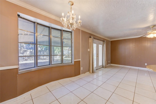 spare room featuring tile patterned floors, ceiling fan with notable chandelier, crown molding, and a textured ceiling