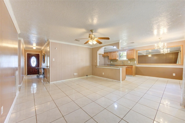 unfurnished living room featuring ornamental molding, a textured ceiling, and light tile patterned floors