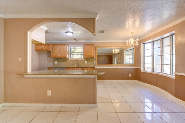 kitchen featuring sink, a notable chandelier, a textured ceiling, light tile patterned floors, and ornamental molding