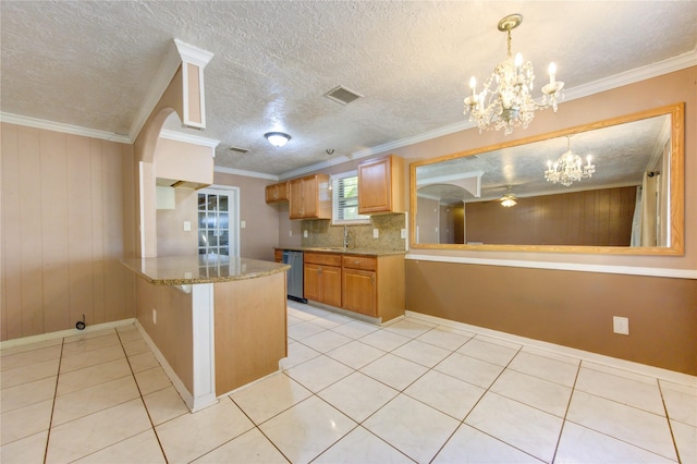 kitchen with kitchen peninsula, stainless steel dishwasher, and crown molding