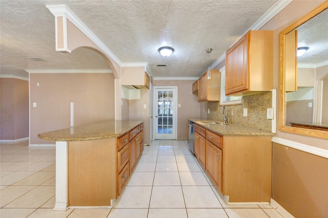 kitchen with dishwasher, light tile patterned floors, ornamental molding, and sink