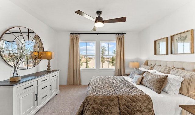 bedroom featuring light colored carpet, ceiling fan, and baseboards