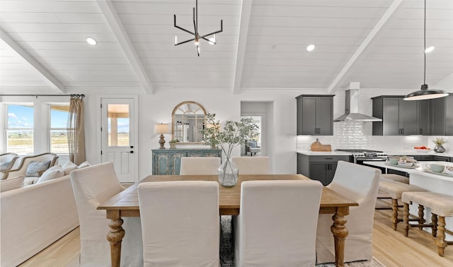 dining room featuring light wood-style flooring, recessed lighting, lofted ceiling with beams, and an inviting chandelier