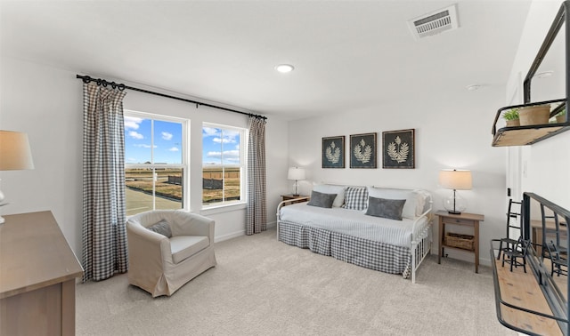 bedroom featuring light colored carpet, visible vents, and baseboards