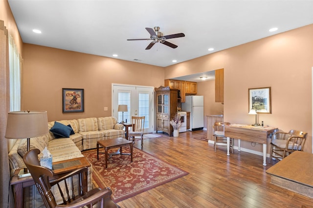 living room with hardwood / wood-style flooring, ceiling fan, and french doors