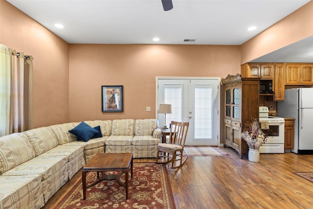 living room featuring dark hardwood / wood-style floors and french doors