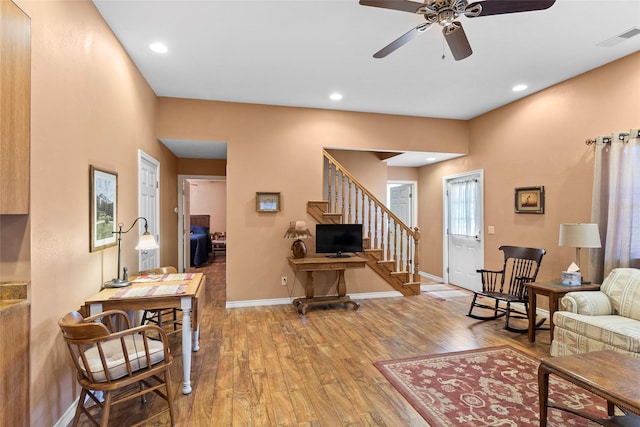 living room with hardwood / wood-style floors and ceiling fan