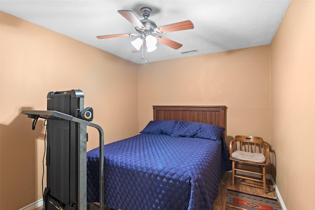 bedroom with ceiling fan and wood-type flooring