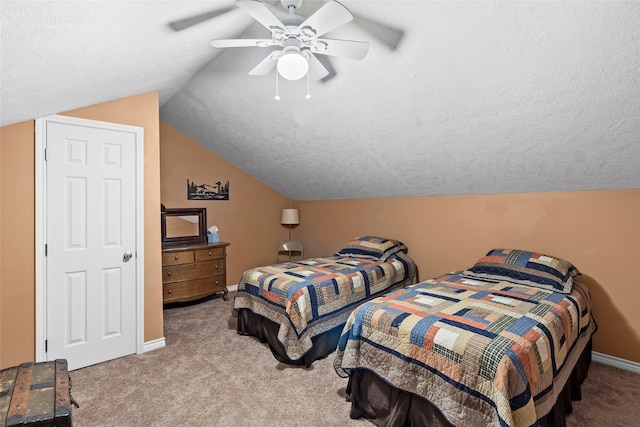 carpeted bedroom featuring a textured ceiling, vaulted ceiling, and ceiling fan