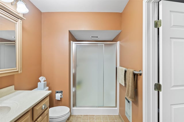 bathroom featuring vanity, toilet, and an enclosed shower