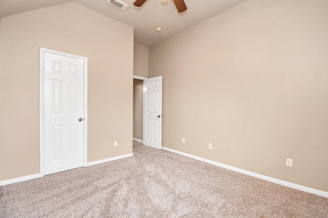 unfurnished bedroom with light colored carpet, vaulted ceiling, and ceiling fan