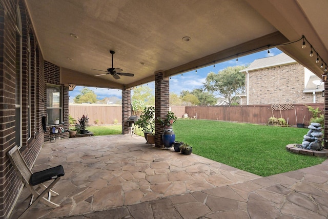 view of patio featuring ceiling fan and a grill