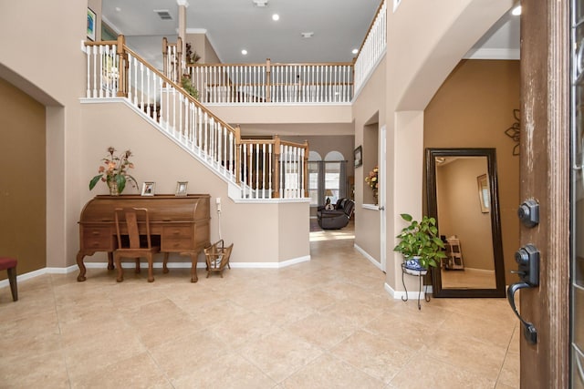 entrance foyer featuring a towering ceiling