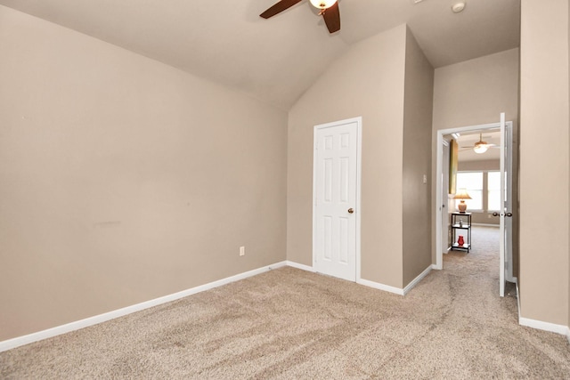 unfurnished bedroom with light carpet, a closet, high vaulted ceiling, and ceiling fan