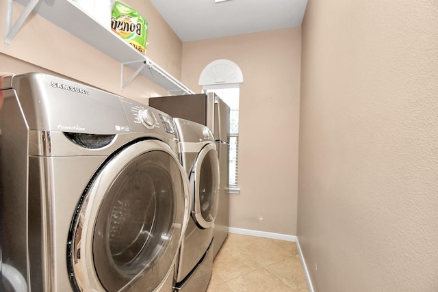 washroom featuring washer and dryer and light tile patterned floors