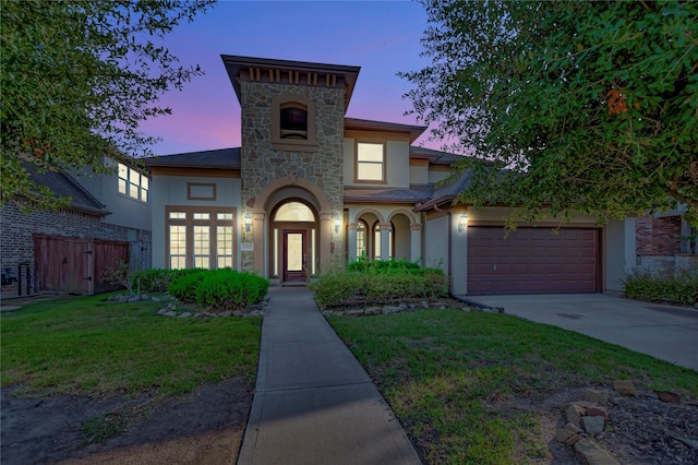 view of front of home featuring a garage and a lawn