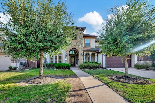 view of front of property featuring a front yard and a garage