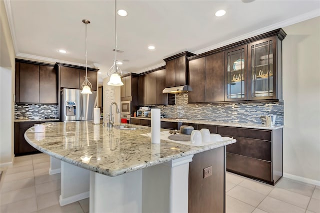 kitchen with a large island, decorative light fixtures, dark brown cabinetry, and appliances with stainless steel finishes