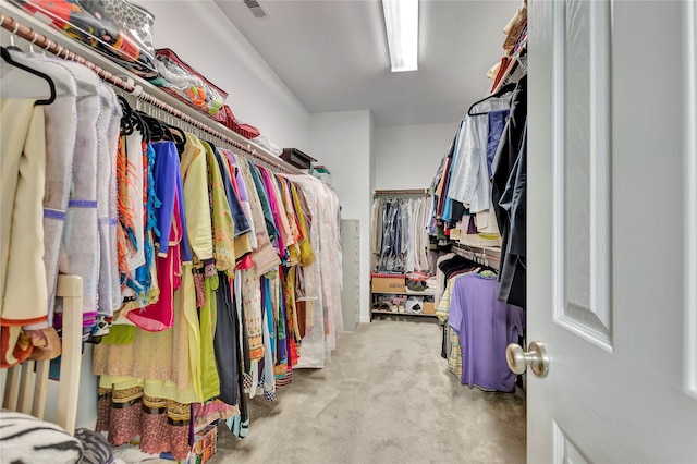 spacious closet featuring light carpet