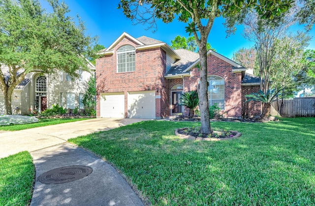 view of property featuring a front yard and a garage