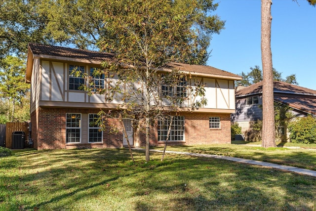 back of property featuring a yard and central AC