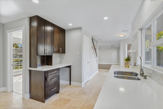 kitchen with dark brown cabinetry and sink