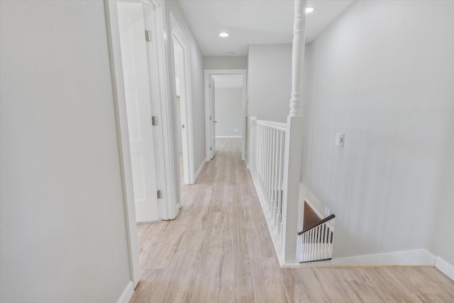 hallway with light hardwood / wood-style flooring