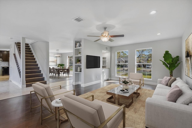 living room featuring ceiling fan and wood-type flooring