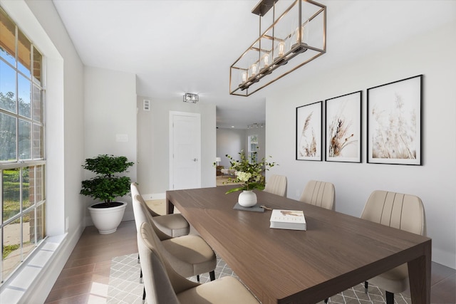 dining room featuring a wealth of natural light, hardwood / wood-style floors, and an inviting chandelier