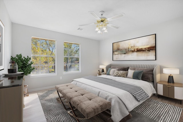 bedroom with ceiling fan and light hardwood / wood-style flooring