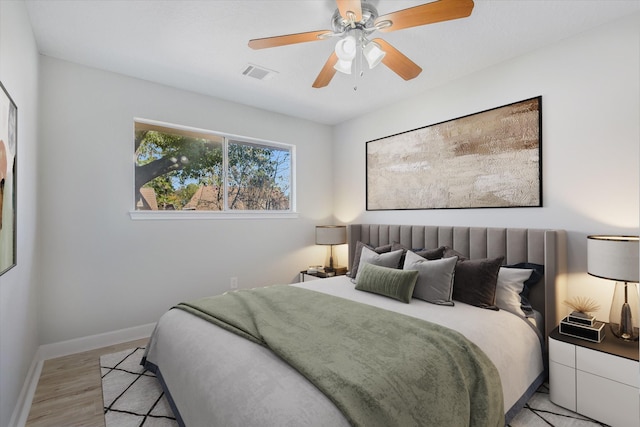 bedroom with ceiling fan and light wood-type flooring