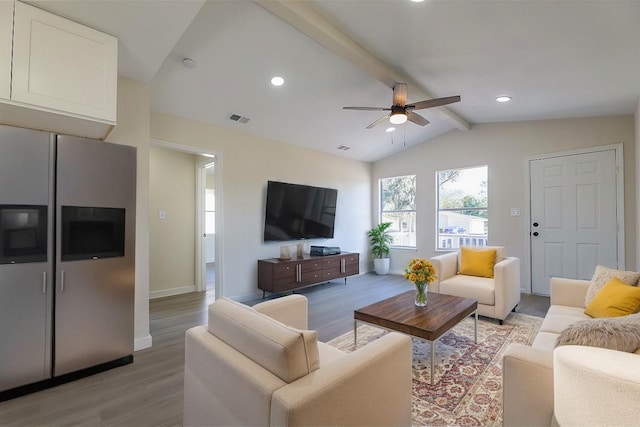 living room featuring lofted ceiling with beams, light hardwood / wood-style floors, and ceiling fan