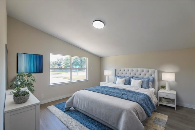 bedroom featuring lofted ceiling and hardwood / wood-style flooring