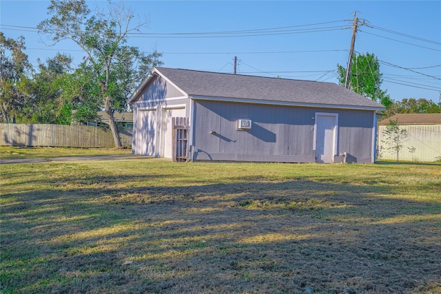 view of outdoor structure with a lawn and a garage