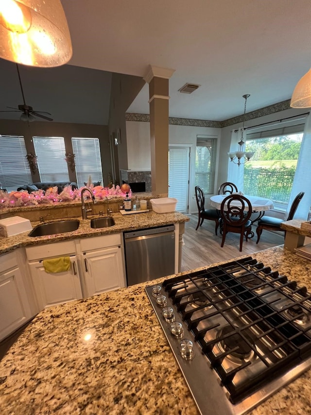 kitchen with sink, white cabinets, light wood-type flooring, and appliances with stainless steel finishes