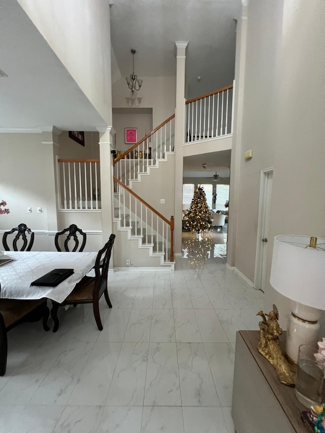 interior space featuring a high ceiling and a notable chandelier