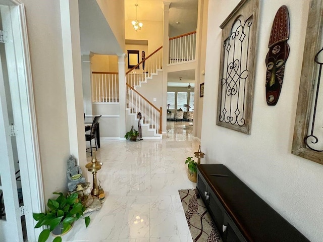 entryway with a high ceiling and an inviting chandelier