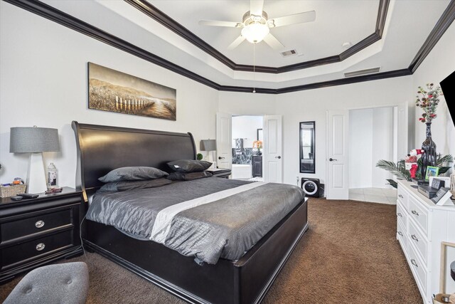 bedroom featuring a raised ceiling, ceiling fan, dark carpet, and ornamental molding