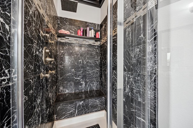 bathroom with a tile shower