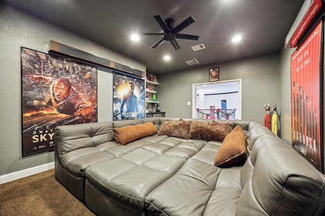 carpeted cinema room with ceiling fan