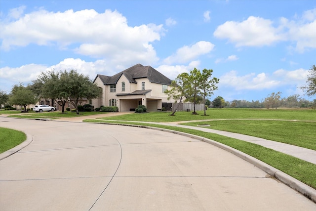 view of front of home with a front lawn and a garage