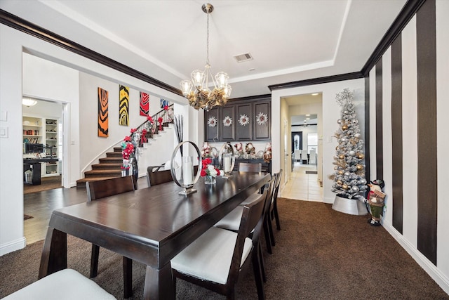 dining area featuring carpet and ceiling fan with notable chandelier