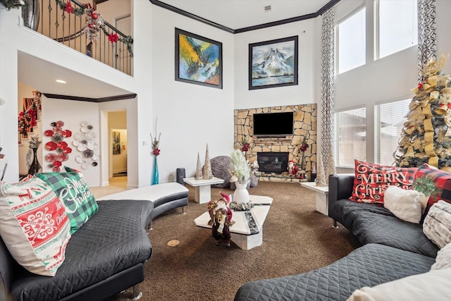 carpeted living room featuring crown molding, a fireplace, and a high ceiling