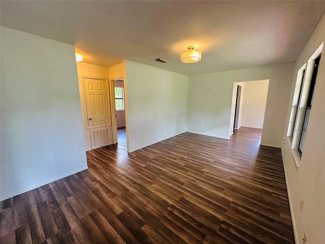 spare room with dark hardwood / wood-style floors