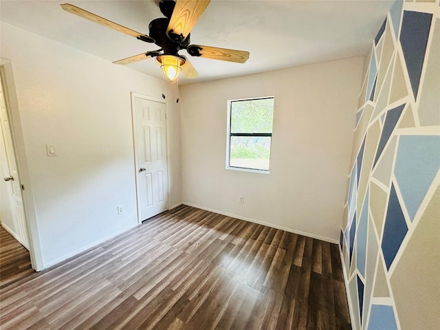 unfurnished bedroom featuring ceiling fan and dark wood-type flooring