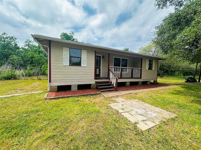 view of front of home with a porch and a front yard