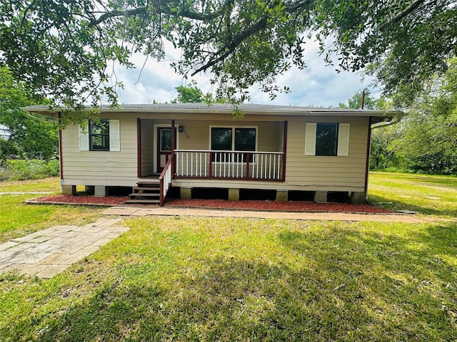 view of front of home with a porch and a front yard