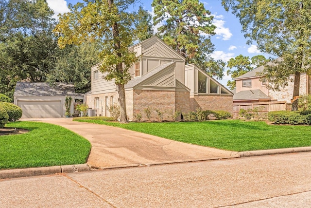 tudor house with a garage, central air condition unit, and a front lawn